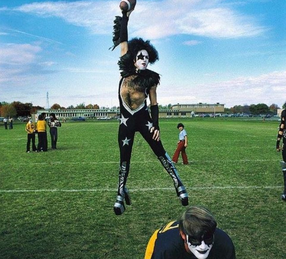 KISS Member Paul Stanley One Hands A Pass During A Visit To A Michigan High School Back In 1975.