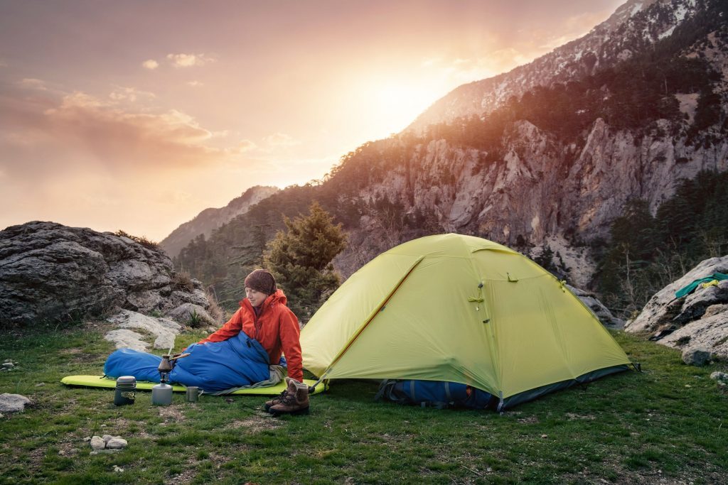 Person Outside Tent In Sleeping Bag