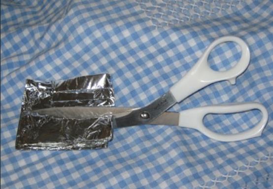 Scissors Cutting Aluminum Foil