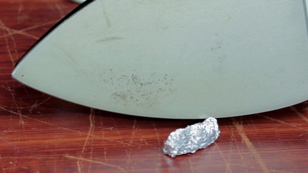 Ball Of Aluminum Foil Next To An Iron